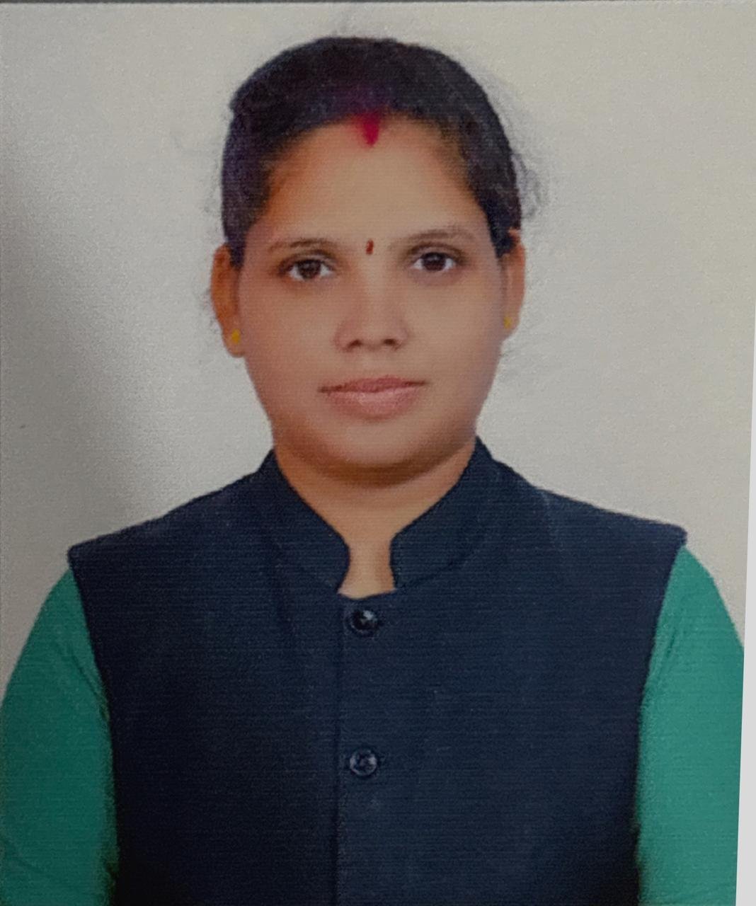 Person wearing a dark vest, green sleeves.